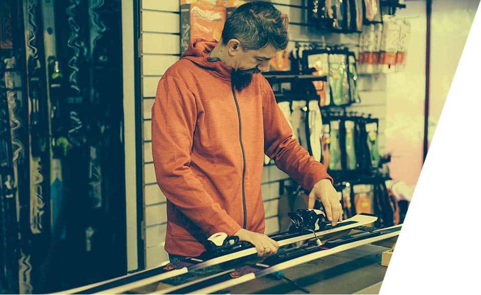 A clerk repairs a customers equipment.